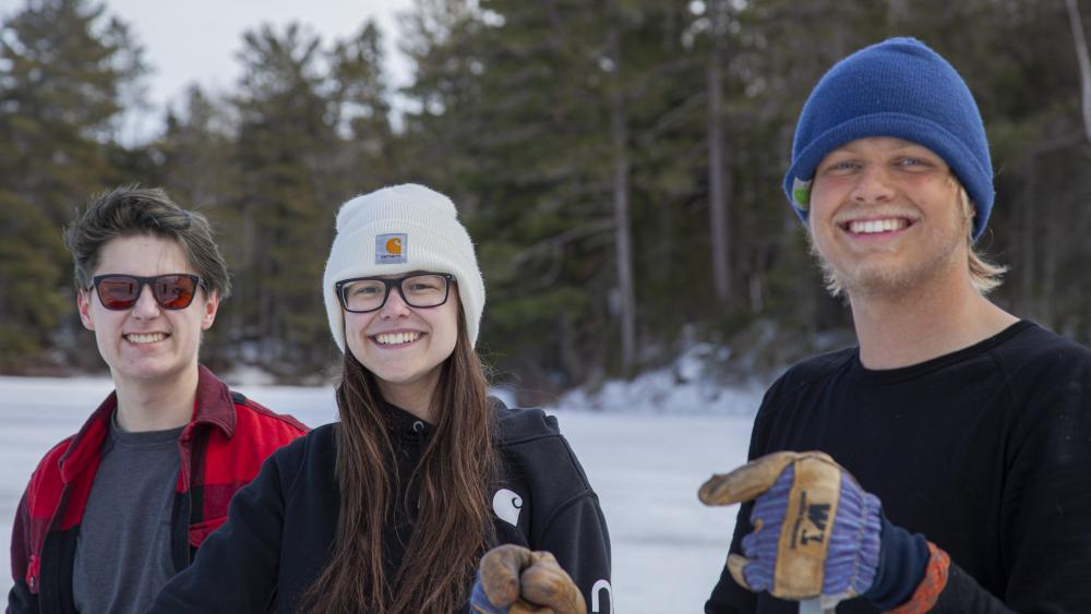 Three people smiling