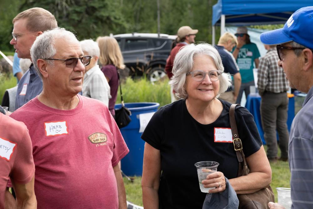 Couple at the garden party talking to another person