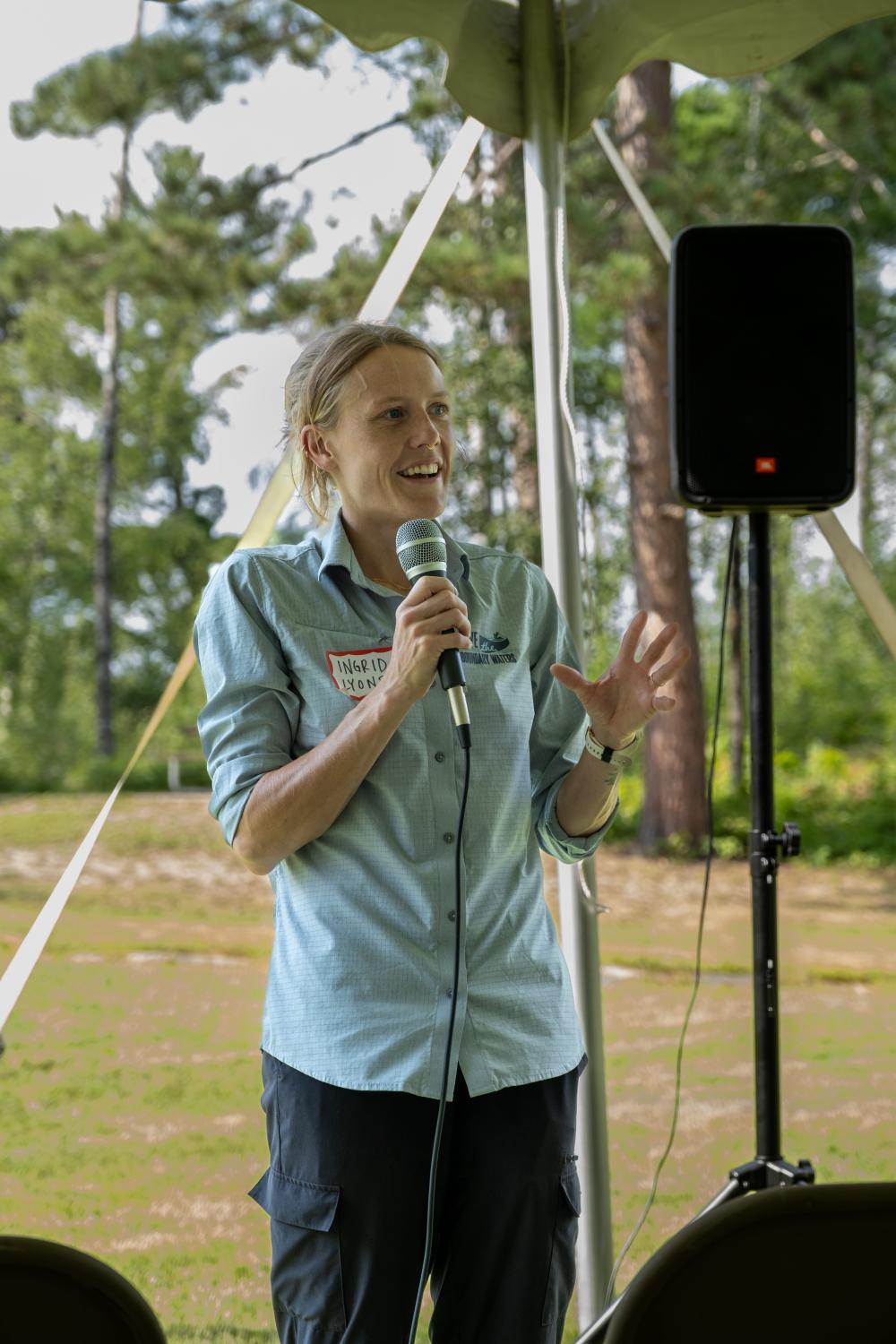 Executive Director Ingrid Lyons speaking to the crowd at the garden party