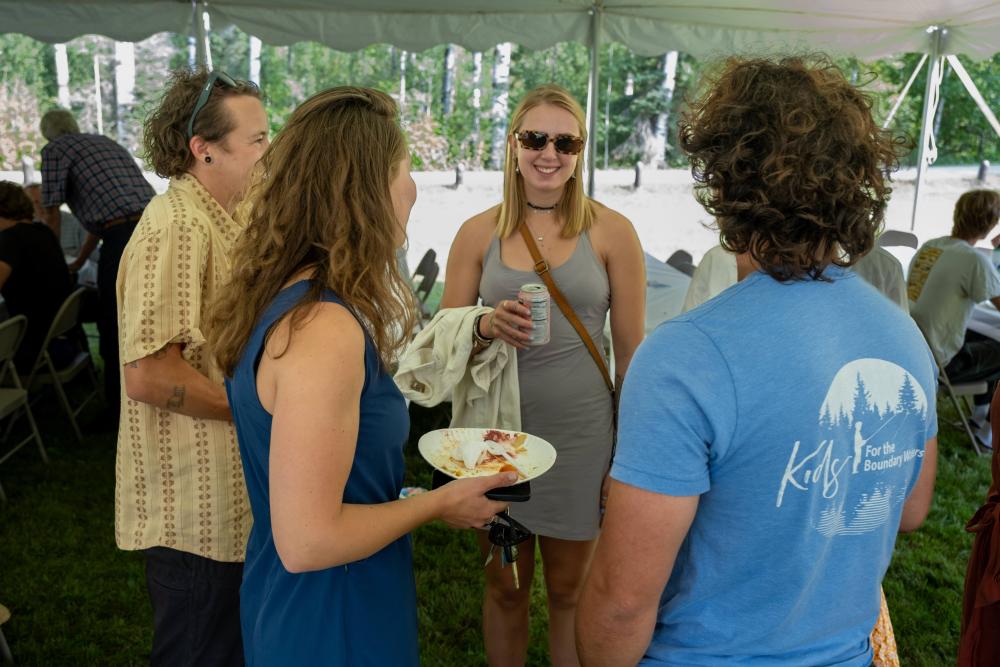 group of young adults at the garden party having a conversation