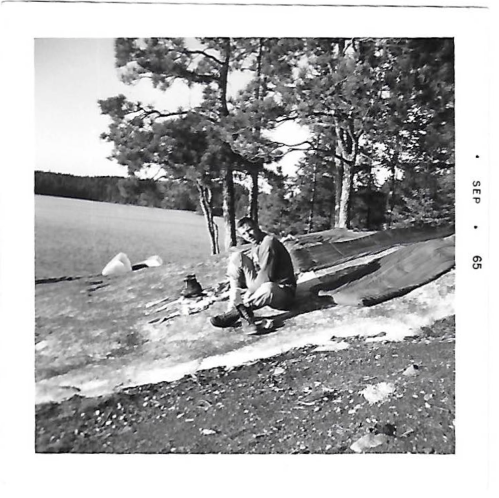 A man sets up to cook next to a lake in the Boundary Waters