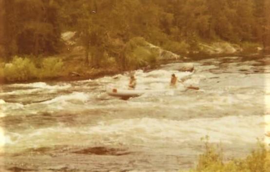 Two men paddle a canoe directly into rapids in the Boundary Waters